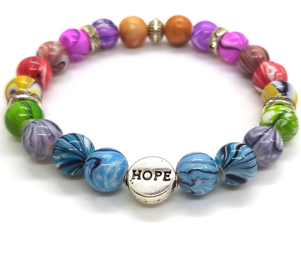 Bracelet élastique en perles à motif encre multicolore.